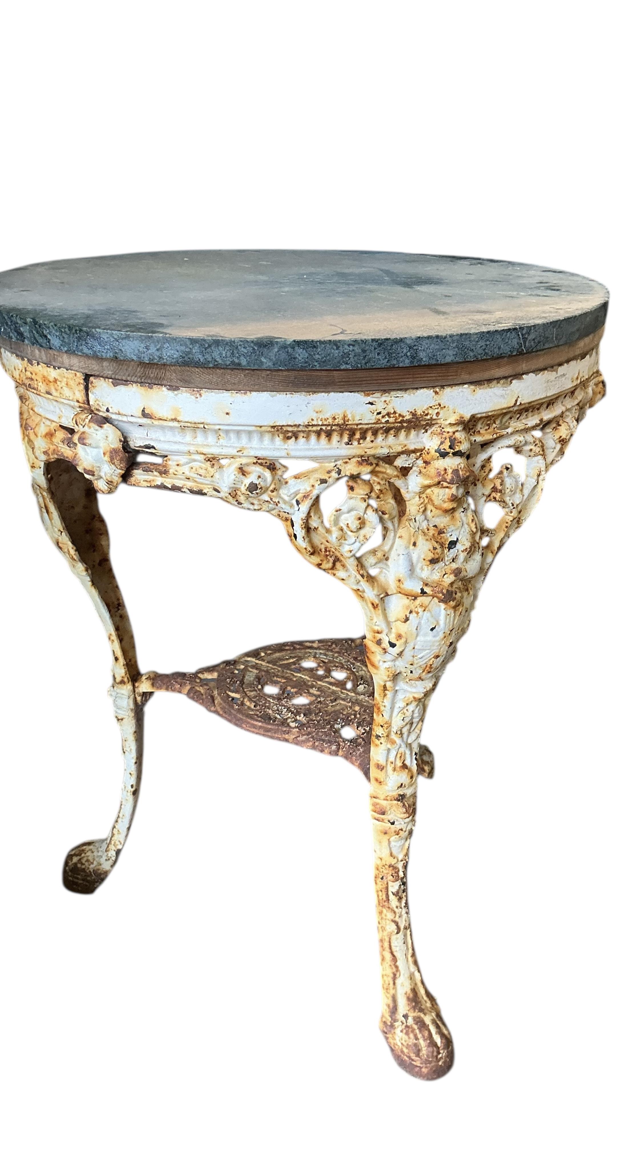 A Victorian painted cast iron Britannia pub table with green marble top, diameter 60cm, height 77cm